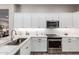 Kitchen features stainless steel appliances, white cabinets, and tile backsplash at 12325 S 179Th S Ave # 0, Goodyear, AZ 85338