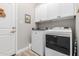 Bright laundry room with white washer, dryer and cabinets for convenient storage at 12325 S 179Th S Ave # 0, Goodyear, AZ 85338