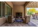 Covered patio features comfortable seating with a blue rug and entertainment options at 12325 S 179Th S Ave # 0, Goodyear, AZ 85338