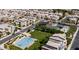 Aerial view of a neighborhood showcasing community amenities, including a pool, basketball court, and green spaces at 1250 N Abbey Ln # 275, Chandler, AZ 85226