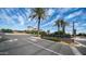 Community entrance with stylish 'Rhythm' signage, enhanced by palm trees and well-maintained landscaping, providing curb appeal at 1250 N Abbey Ln # 275, Chandler, AZ 85226