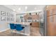 Modern kitchen featuring granite countertops, stainless steel appliances, and blue accent chairs at the island at 1250 N Abbey Ln # 275, Chandler, AZ 85226