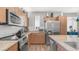 Bright kitchen with stainless steel appliances, granite countertops, and ample cabinet space for storage at 1250 N Abbey Ln # 275, Chandler, AZ 85226