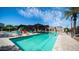 Community pool and lounge area with ample seating, shade structures, and lush landscaping at 1250 N Abbey Ln # 275, Chandler, AZ 85226
