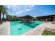 Large community pool featuring a central covered table, swim area, and plenty of lounge seating for relaxing and socializing at 1250 N Abbey Ln # 275, Chandler, AZ 85226