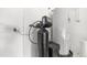 Utility room with modern water softener system and hot water heater for efficient home maintenance at 1250 N Abbey Ln # 275, Chandler, AZ 85226