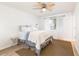 Bright bedroom features a ceiling fan, natural light, and a cozy rug over wood flooring to provide a tranquil space at 12739 W Prospect Dr, Sun City West, AZ 85375
