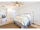 Bedroom with ceiling fan and seating area boasts natural light and a tranquil atmosphere at 12739 W Prospect Dr, Sun City West, AZ 85375
