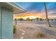 Striking exterior view showcases desert landscaping and a vibrant sunset sky at 12739 W Prospect Dr, Sun City West, AZ 85375