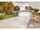 Attractive single-story home boasts a large driveway, attached two-car garage, and manicured front yard at 12739 W Prospect Dr, Sun City West, AZ 85375