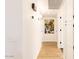 Bright hallway with hardwood floors and white paneled storage closets at 12739 W Prospect Dr, Sun City West, AZ 85375