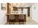 Charming kitchen features granite countertops, wooden cabinetry, and a modern refrigerator at 12739 W Prospect Dr, Sun City West, AZ 85375