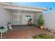 Covered patio with brick pavers, mature landscaping, and serene outdoor space, ideal for relaxation and entertaining at 13418 N 108Th Dr, Sun City, AZ 85351