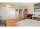 Bright bedroom features closet, white-washed walls, and wood-look flooring at 13418 N 108Th Dr, Sun City, AZ 85351