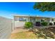 Single-story home featuring an enclosed front patio, garden, and covered entrance, enhancing its charm and curb appeal at 13418 N 108Th Dr, Sun City, AZ 85351