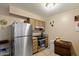 Bright kitchen features modern stainless steel appliances and wood cabinets at 13418 N 108Th Dr, Sun City, AZ 85351