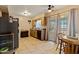Bright kitchen with tile flooring, wood cabinets, stainless steel refrigerator, and sliding glass doors leading to patio at 13418 N 108Th Dr, Sun City, AZ 85351