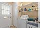 Utility room features shelving and a full size washer and dryer at 13418 N 108Th Dr, Sun City, AZ 85351