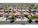 Aerial view of a neighborhood showcasing a home with a solar panel system and backyard pool at 13965 N 135Th Dr, Surprise, AZ 85379