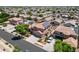 This aerial view shows a home with a solar panel system in a neighborhood with mature trees at 13965 N 135Th Dr, Surprise, AZ 85379