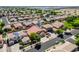 An aerial view of a suburban neighborhood showcasing well-maintained homes, lush trees, and community streets in a vibrant setting at 13965 N 135Th Dr, Surprise, AZ 85379