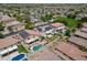 This aerial perspective showcases homes equipped with solar panels, surrounded by lush landscaping and sparkling swimming pools at 13965 N 135Th Dr, Surprise, AZ 85379