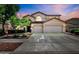 Charming two-story home with a three car garage and landscaped front yard at 13965 N 135Th Dr, Surprise, AZ 85379
