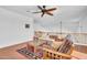 Cozy loft area with hardwood floors, a ceiling fan, and a comfortable couch at 13965 N 135Th Dr, Surprise, AZ 85379