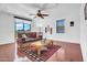 Comfortable living room with hardwood floors, a ceiling fan, and a sliding glass door to the outdoors at 13965 N 135Th Dr, Surprise, AZ 85379