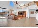 Spacious living room with a high ceiling, media center, comfortable seating, and natural light at 13965 N 135Th Dr, Surprise, AZ 85379