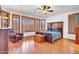 Relaxing main bedroom with wood shutters, hardwood floor, and comfortable furniture at 13965 N 135Th Dr, Surprise, AZ 85379