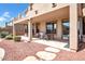 This covered patio features comfortable seating and a well manicured yard with stone accents at 13965 N 135Th Dr, Surprise, AZ 85379