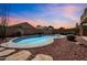 A kidney-shaped pool is surrounded by desert landscaping creating a private backyard oasis at 13965 N 135Th Dr, Surprise, AZ 85379