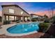 Enjoy the backyard pool and adjacent covered patio of this beautiful two-story home at 13965 N 135Th Dr, Surprise, AZ 85379