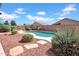 Enjoy this backyard oasis with a pool and desert landscaping, perfect for outdoor entertaining at 13965 N 135Th Dr, Surprise, AZ 85379