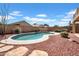 Relax by the pool in this yard featuring desert landscaping under a sunny, blue sky at 13965 N 135Th Dr, Surprise, AZ 85379