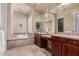 A bathroom with double sinks, tile floors, and a soaking tub at 16540 E El Lago Blvd # 2, Fountain Hills, AZ 85268