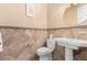 A tiled bathroom with a pedestal sink, decorative accents, and neutral wall coloring at 16540 E El Lago Blvd # 2, Fountain Hills, AZ 85268