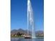 Majestic fountain soaring high into a blue sky, with mountains visible in the background at 16540 E El Lago Blvd # 2, Fountain Hills, AZ 85268