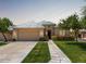 Charming single-story home with a tile roof, manicured lawn, and welcoming curb appeal at 16540 E El Lago Blvd # 2, Fountain Hills, AZ 85268