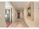 Long hallway featuring beautiful tile flooring, artwork, and access to various rooms at 16540 E El Lago Blvd # 2, Fountain Hills, AZ 85268