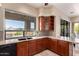 A kitchen featuring wood cabinets, stone countertops, and a large window with backyard views at 16540 E El Lago Blvd # 2, Fountain Hills, AZ 85268
