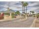 Charming Villa Estates street view with desert landscaping, palm trees, and paved roadway at 16540 E El Lago Blvd # 2, Fountain Hills, AZ 85268