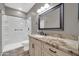 Bathroom featuring shower stall, vanity, and large mirror at 17429 W Red Bird Rd, Surprise, AZ 85387