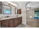 A bathroom with double sinks, vanity, and neutral color scheme create a serene and functional space at 17429 W Red Bird Rd, Surprise, AZ 85387