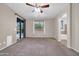 A spacious bedroom with an outdoor view features carpet flooring and natural light at 17429 W Red Bird Rd, Surprise, AZ 85387