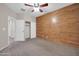 Cozy bedroom with feature wall, ceiling fan, carpet, and closet at 17429 W Red Bird Rd, Surprise, AZ 85387
