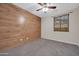 Bedroom featuring accent wall, ceiling fan, carpet, and natural light at 17429 W Red Bird Rd, Surprise, AZ 85387