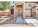 Charming front entrance with brick accents, security door, and well-kept landscaping at 17429 W Red Bird Rd, Surprise, AZ 85387