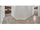 Hallway with tile flooring, view to kitchen, and connecting rooms at 17429 W Red Bird Rd, Surprise, AZ 85387